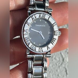 READ… Tiffany & Co Atlas Stainless Steel Quartz Date Watch Swiss Roman Bezel